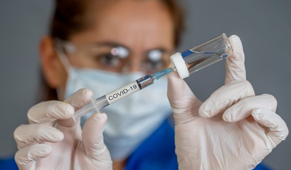 Covid-19,Coronavirus,Vaccine.,Doctor,Scientist,With,Syringe,Analyzing,Virus,Sars-cov-2